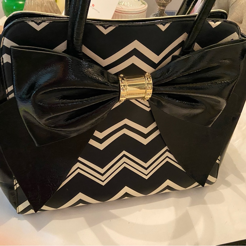 Betsy Johnson black and white bow bag with floral interior